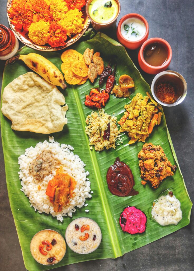 A vibrant display of Kerala Sadya on banana leaf, featuring traditional Onam dishes.